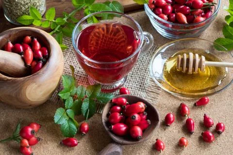 A cup of rose hip tea on a table Stock Photos