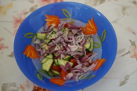 Cup with salad on the kitchen table Stock Photos