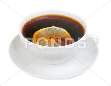 Cup on saucer with tea and slice of lemon Stock Photos