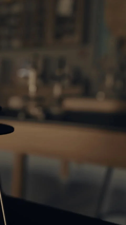 Cup sits on a kitchen counter while a warm light shines in the background Stock Footage 335688491