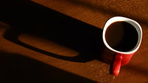 A cup of steaming coffee on a wooden table Stock Footage 139650262