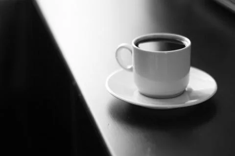 Cup of strong coffee on black table black and white photo Foto stock