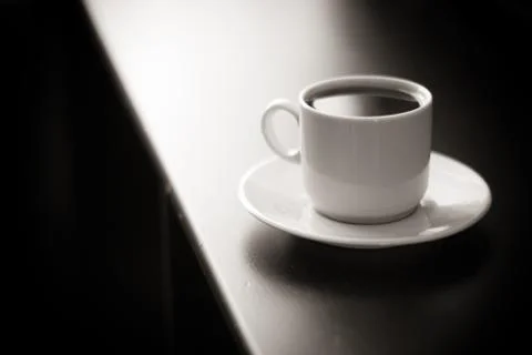 Cup of strong coffee on black table black and white photo Stock Photos