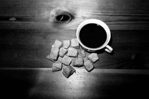 The Cup is on the table lying next to a sugar black and white image. Stock-Fotos
