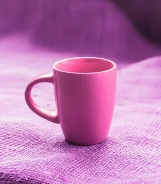Cup on a table by the window on sackcloth isolated, with a hot drink invigora Stock Photos
