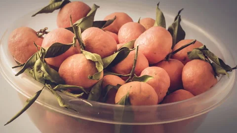 Cup of tangerines with leaf on white background Stock Footage 150807677