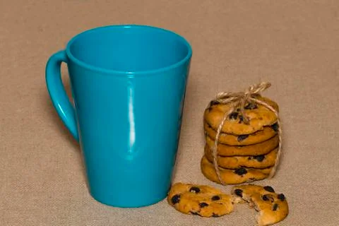 A Cup of tea and biscuits on on background burlap Stock Photos