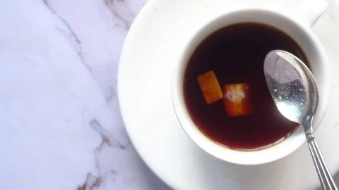 Cup of tea and brown sugar cube on table Stock Footage 144610191