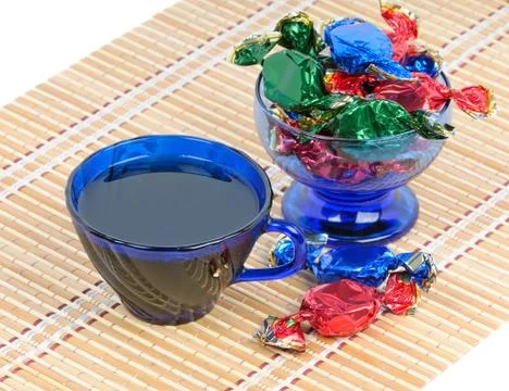 A cup of tea and chocolates Stock Photos