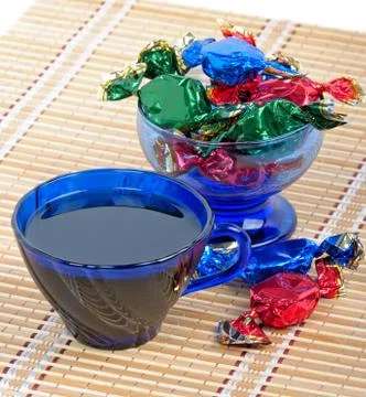 A cup of tea and chocolates Stock Photos