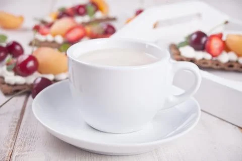 Cup of tea and crisp bread with creme cheese, fruit and berries Photos
