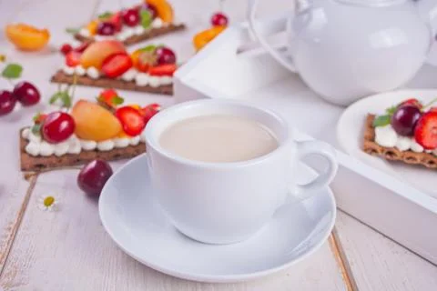 Cup of tea and crisp bread with creme cheese, fruit and berries Stock Photos