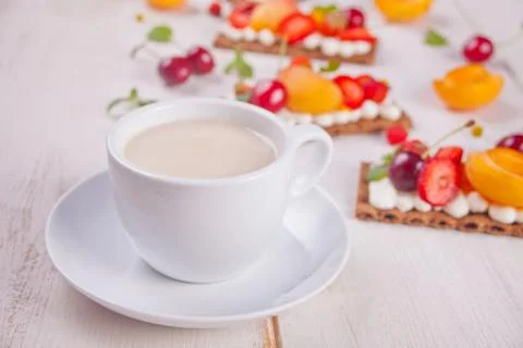 Cup of tea and crisp bread with creme cheese, fruit and berries Stock Photos