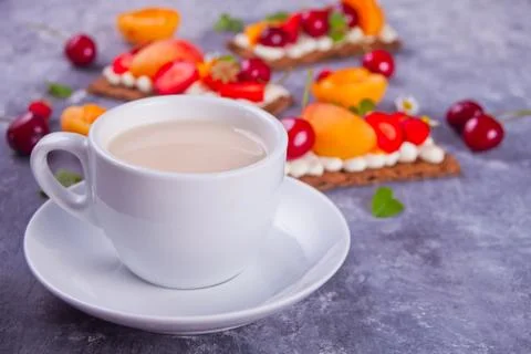 Cup of tea and crisp bread with creme cheese, fruit and berries Stock Photos