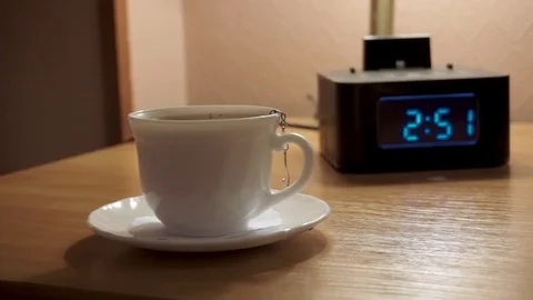 A Cup of tea and a digital watch, alarm Stock Footage 103388659
