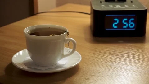A Cup of tea and a digital watch, alarm Stock Footage 103388765