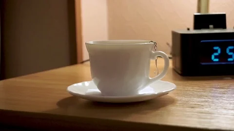 A Cup of tea and a digital watch, alarm Stock Footage 103388874