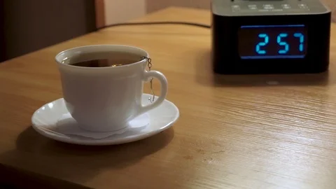 A Cup of tea and a digital watch, alarm Stock Footage 103389020