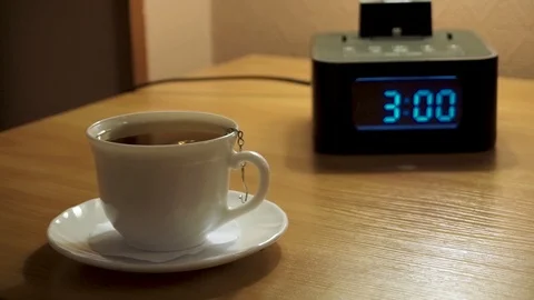 A Cup of tea and a digital watch, alarm Stock Footage 103389267