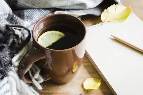 A cup of tea and empty notebook for sketch. Stock Photos