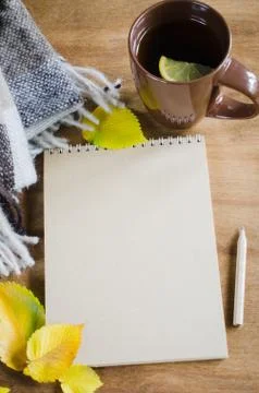 A cup of tea and empty notebook for sketch. Stock Photos