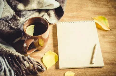 A cup of tea and empty notebook for sketch. Stock Photos