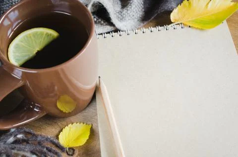 A cup of tea and empty notebook for sketch. Stock Photos