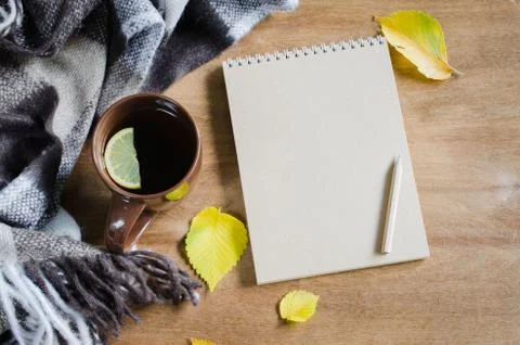 A cup of tea and empty notebook for sketch. Stock Photos