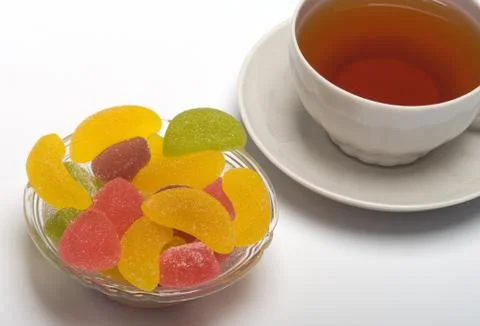 Cup of tea and fruit candy. Stock Photos