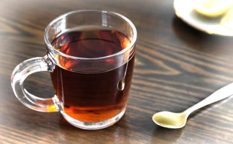 A Cup of tea and lemon on the table. Stock Photos