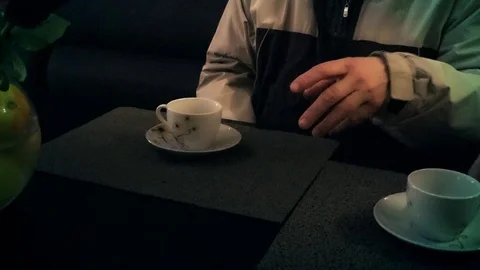 A cup of tea and a man's hand in a cafe 스톡 동영상 88324640