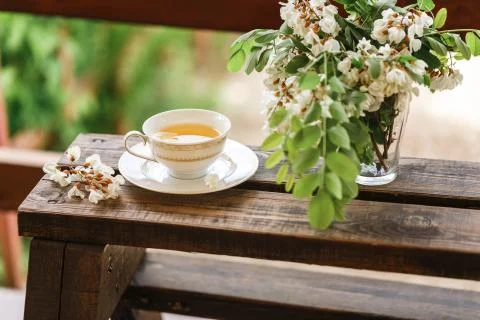 A cup of tea and a saucer on veranda Stock Photos