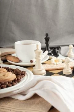A cup of tea and some chess figures Stock Photos