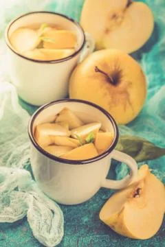 Cup of tea with apples and basil Stock Photos