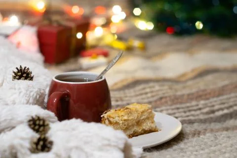 Cup of tea on a background of a Christmas tree with luminous lights Stock Photos