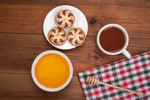 Cup of tea biscuits and honey on wooden background. Stock Photos