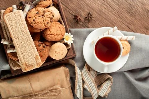 A cup of tea with biscuits tray around. Top view Stock Photos