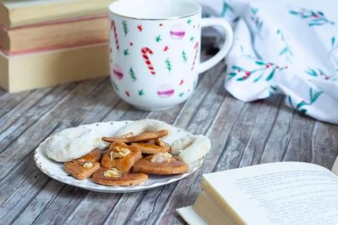 Cup with tea, cakes and open book Stock Photos
