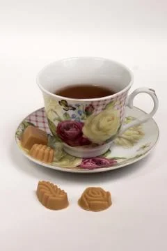Cup of tea with candies Stock Photos