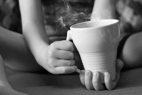 Cup of tea in children's hands Stock Photos