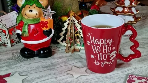 Cup of tea on Christmas decorated table. Stock Footage 228869443