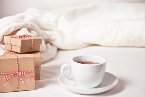 Cup of tea, Christmas gift boxes, knitted plaid on the white background Photos