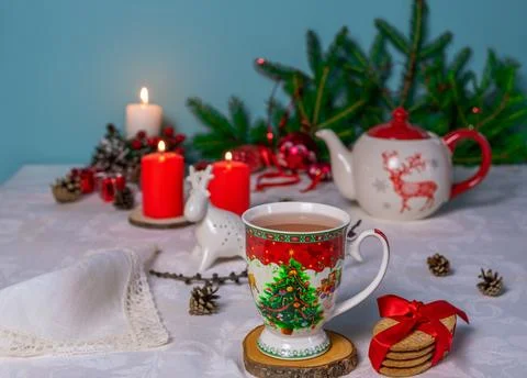 A cup of tea with a Christmas pattern on a table with a linen tablecloth Stock Photos