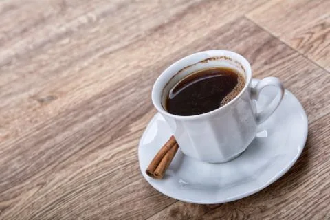 A cup of tea with cinnamon on a table Foto stock