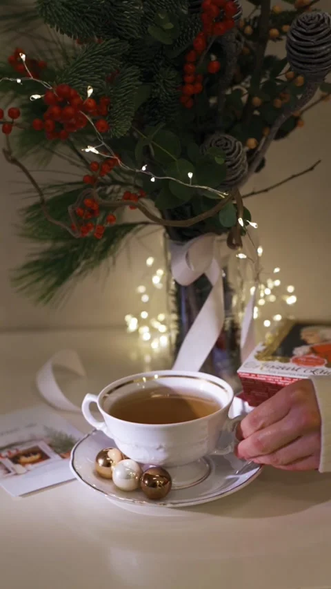 Cup of tea close-up. Decorated christmas tree on background Stock Footage 224895462