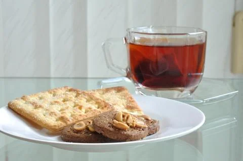 Cup of tea with cookie and bread, tea-break. Stock Photos