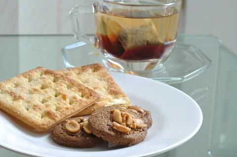 Cup of tea with cookie and bread, tea-break. Stock Photos