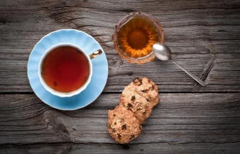 Cup of tea, cookies stack and honey on a wooden background 写真素材