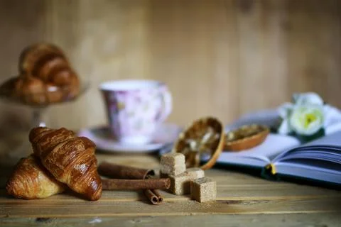 Cup with tea croissant book 写真素材