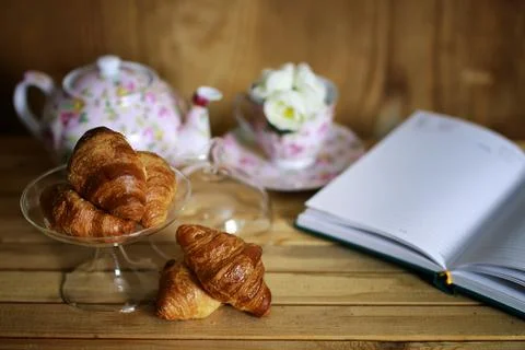 Cup with tea croissant book 写真素材